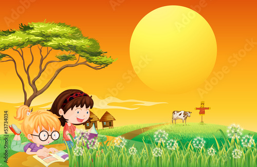 Two girls reading books at the farm