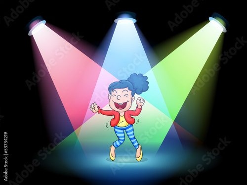 A girl dancing in the middle of the stage