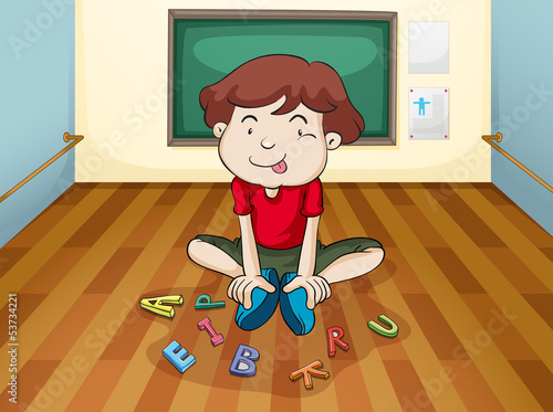 A silly boy playing letters