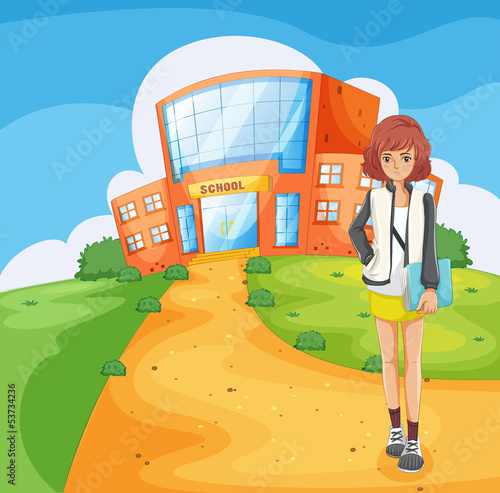 A lady standing outside the school building