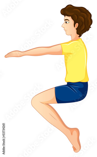 A young man wearing a yellow shirt doing yoga