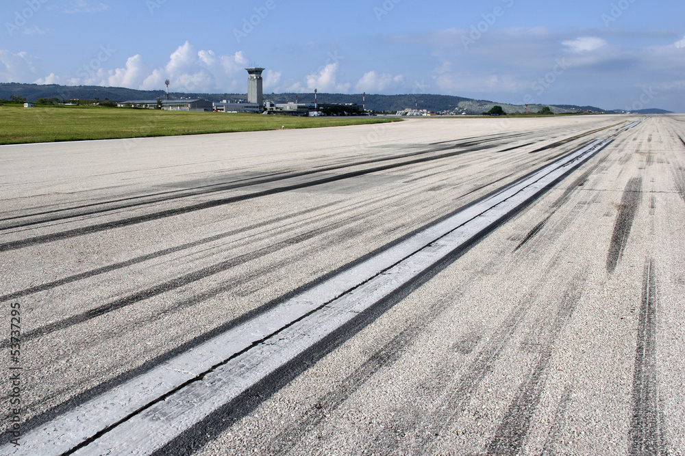 Fototapeta premium Concrete runway of Split airport with traces of airplane wheels