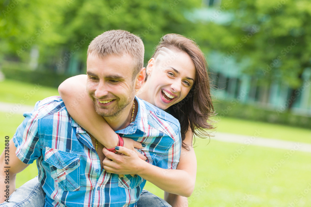 Fototapeta premium Young Couple having Piggyback Ride