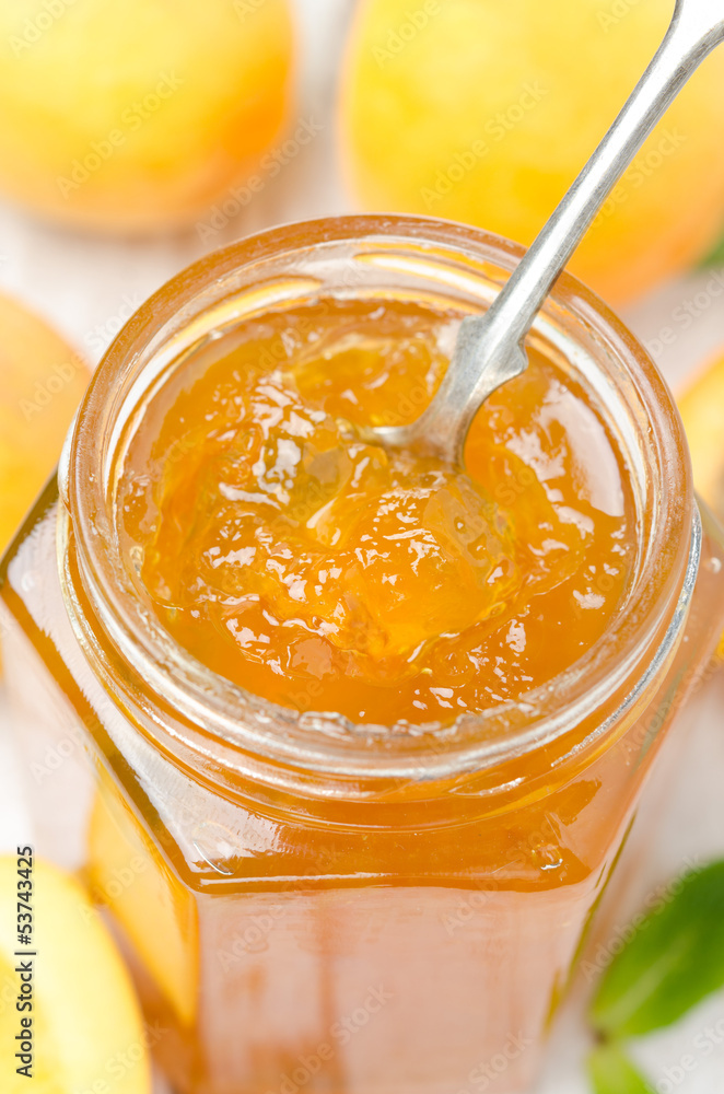 apricot marmalade in a spoon close-up, vertical apricot marmalade in a spoon close-up, vertical