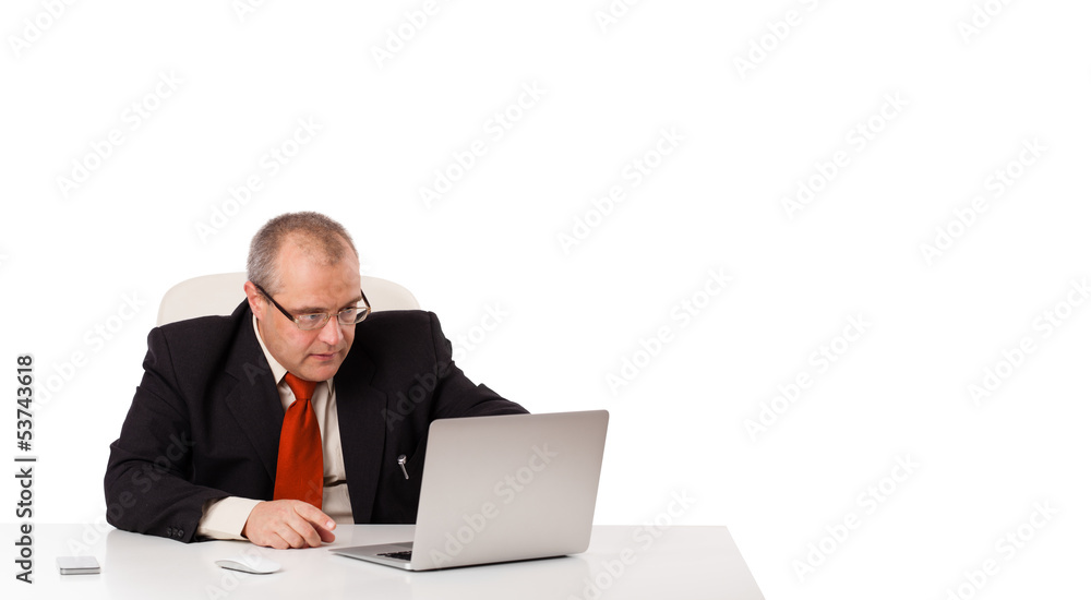 buisnessman sitting at desk and looking laptop with copy space buisnessman sitting at desk and looking laptop with copy space