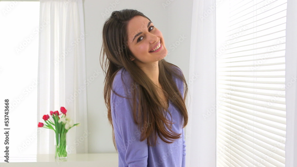 Woman standing by window Woman standing by window