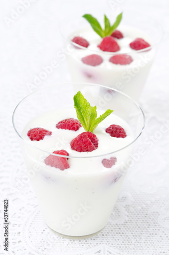 panna cotta with fresh raspberries, vertical