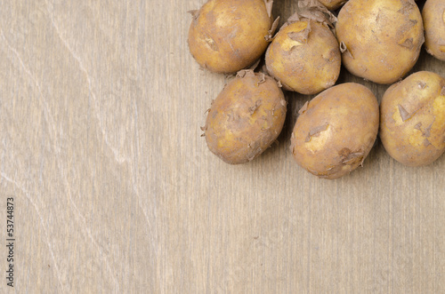 potatoes on a wooden background and space for text