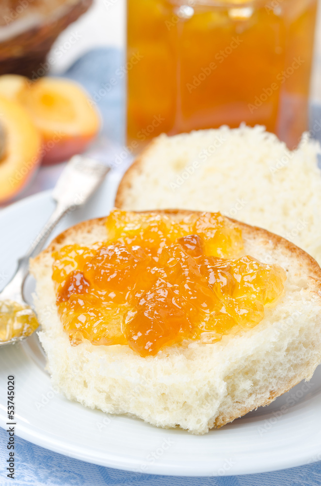 Sweet bun with apricot jam close-up, vertical Sweet bun with apricot jam close-up, vertical