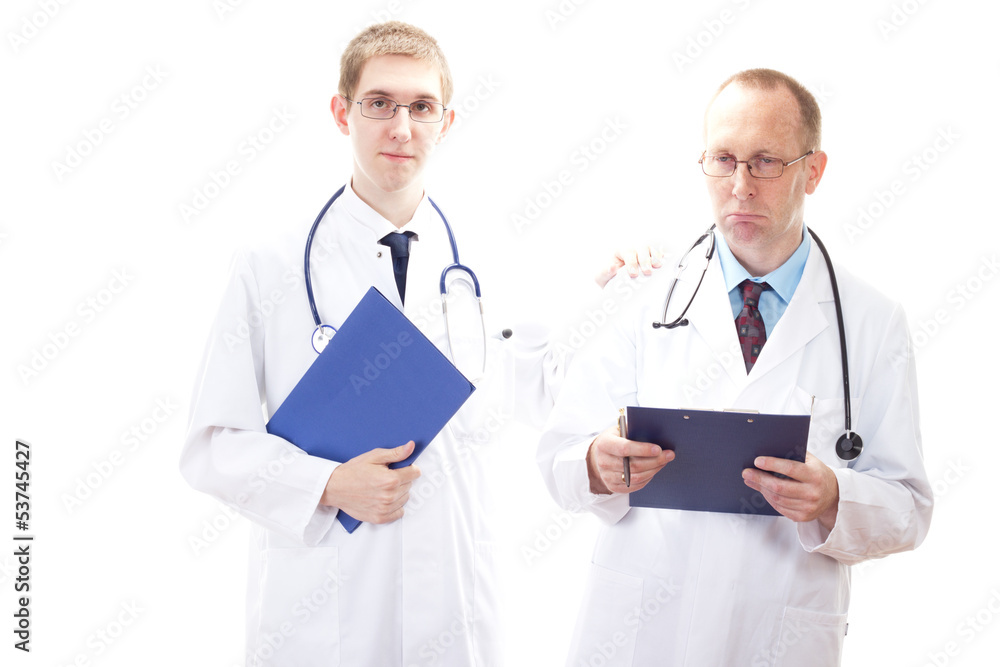 Young medical doctor cheering depressive doctor up Young medical doctor cheering depressive doctor up