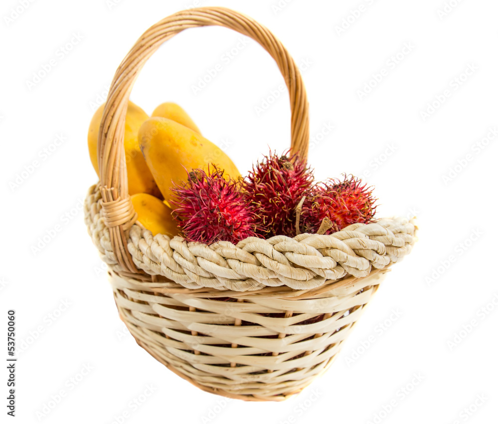 Rambutan and mango fruits in a basket over white background Rambutan and mango fruits in a basket over white background