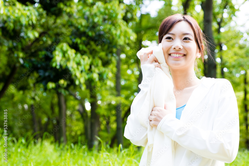 young asian woman relaxing in the park young asian woman relaxing in the park