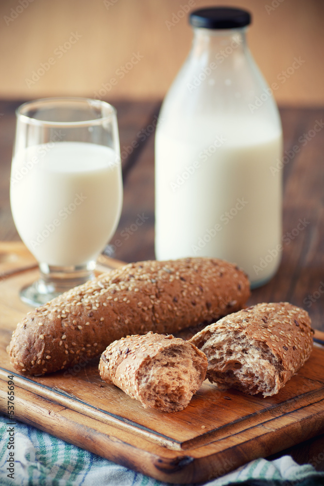 Rolls with a glass of milk on wooden table Rolls with a glass of milk on wooden table