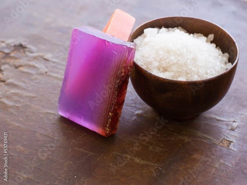 Spa products on wooden background. Sea salt, soap with natural c photo