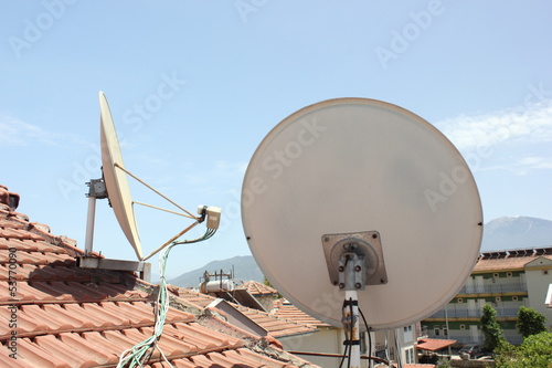 Satallite dish's on top of roofing photo