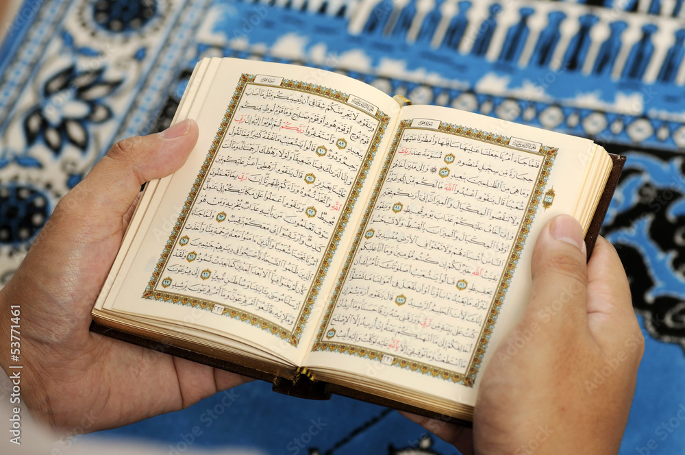 Fototapeta premium Young Man Reading The Holy Koran