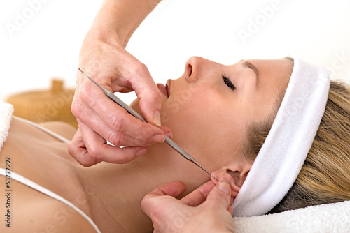 Alternative practitioner using auriculotherapy techniques.