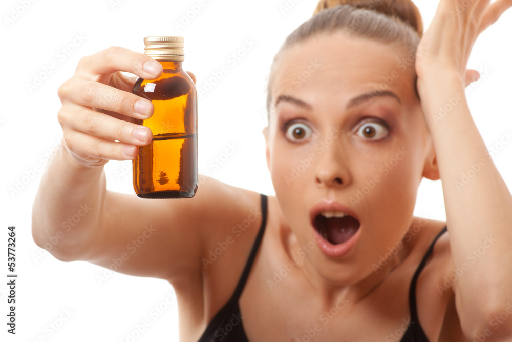 Fototapeta premium woman holding a bottle of medicine, isolated on white background