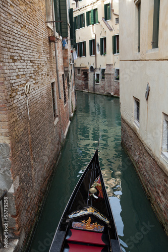 Narrow canal with gondolas in Venice, Italy