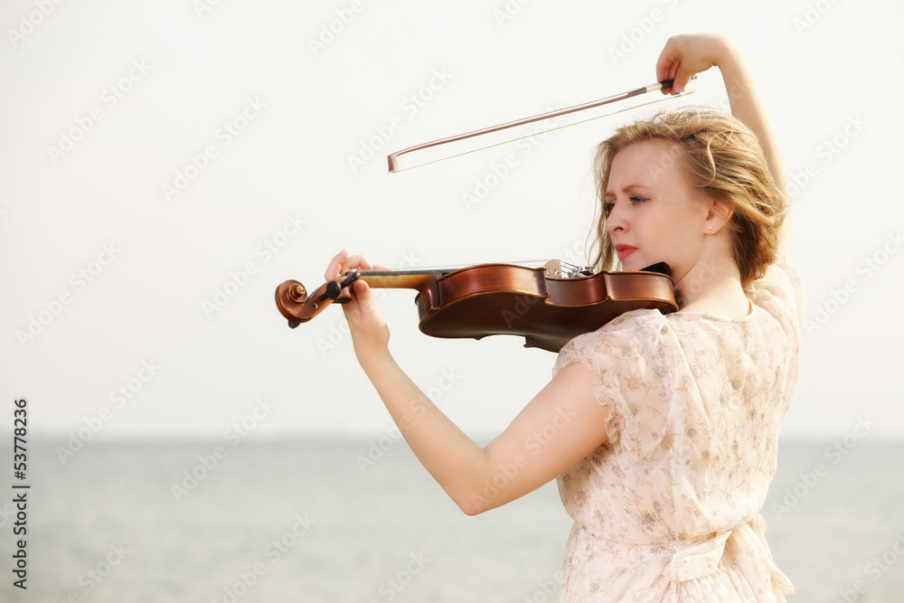 The blonde girl with a violin outdoor
