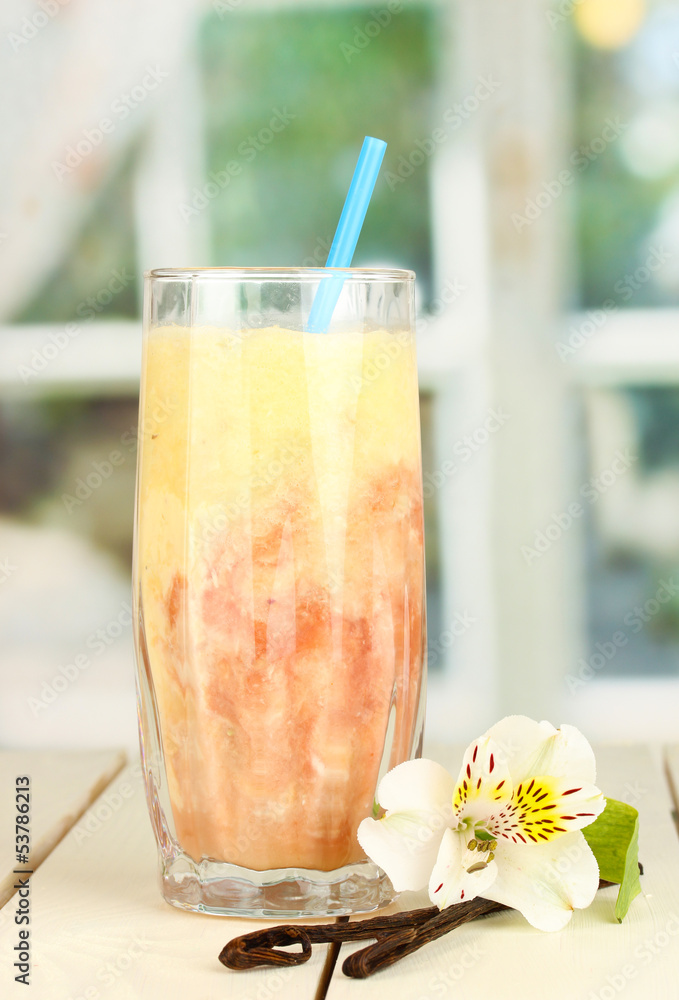 Delicious fruit smoothie on wooden table on window background Delicious fruit smoothie on wooden table on window background