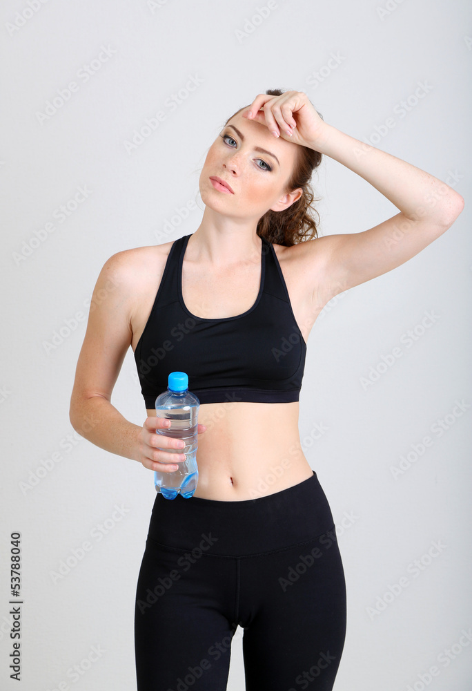 Beautiful young woman with bottle of water Beautiful young woman with bottle of water
