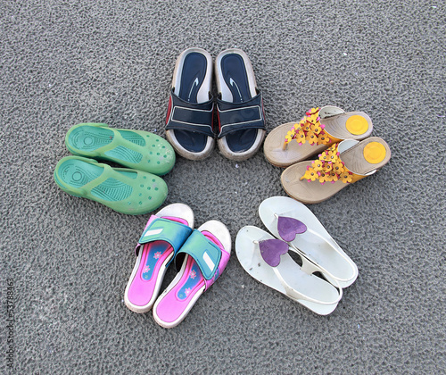 A colllection of shoes with a star designed on the sand beach photo