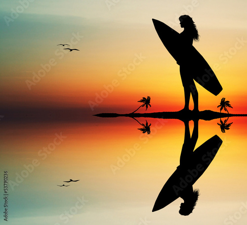 Girl surfing at sunset #53790236