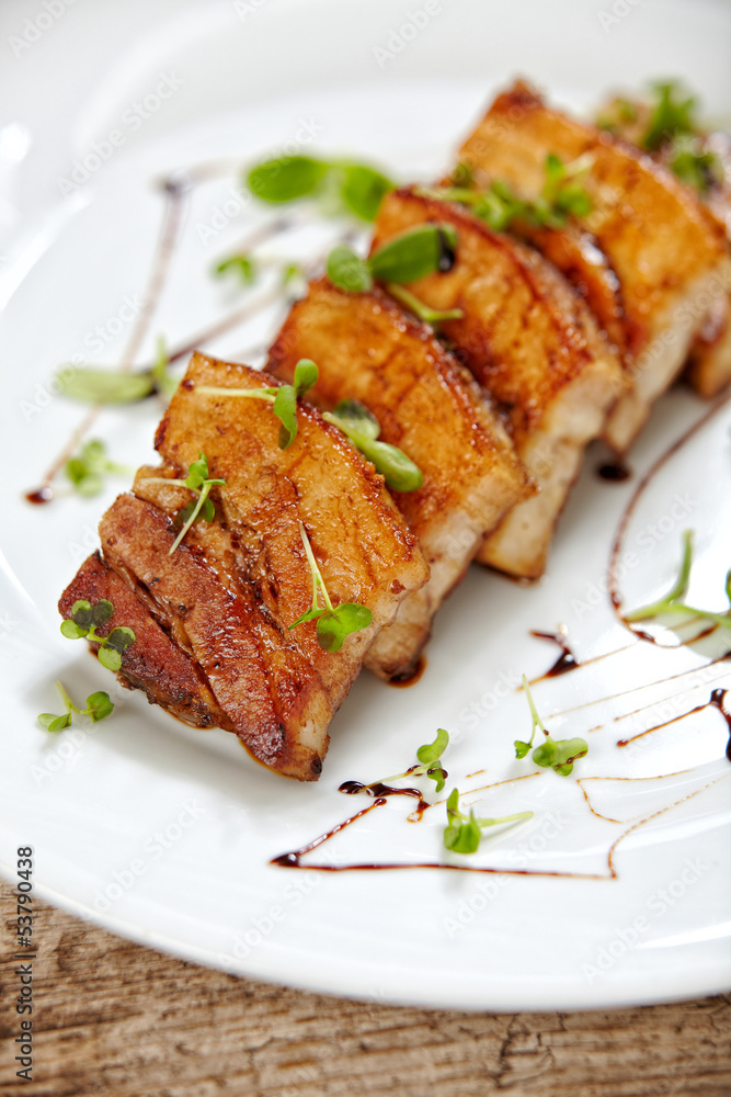 grilled pork on white plate, restaurant portion grilled pork on white plate, restaurant portion