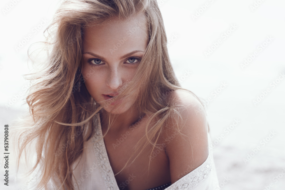 Fototapeta premium Portrait of a beautiful woman, the wind fluttering hair