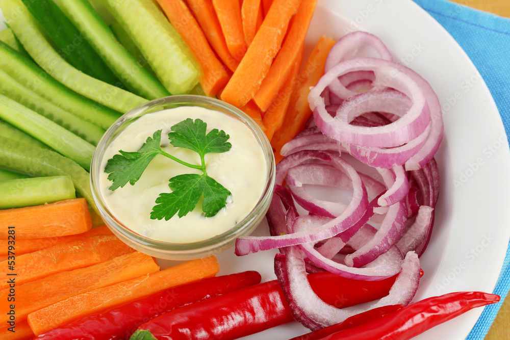 Assorted raw vegetables sticks in plate close up