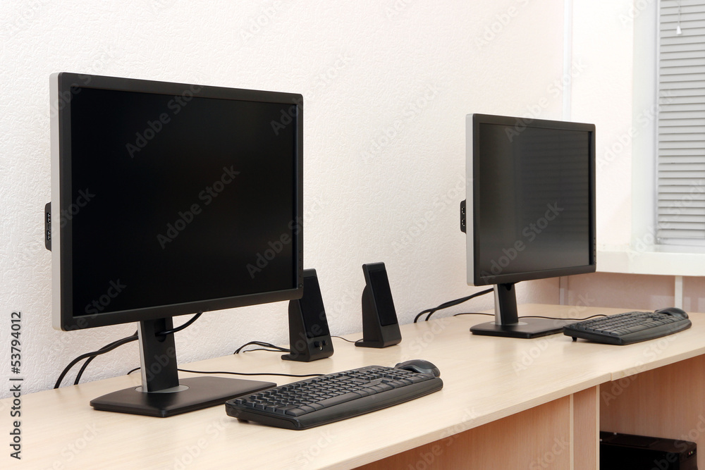Computers on tables in room Computers on tables in room