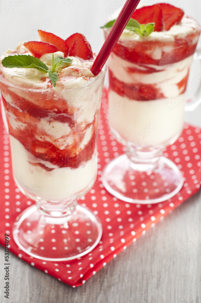 fresh strawberries with whipped cream and mint on the table fresh strawberries with whipped cream and mint on the table