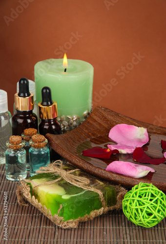 Spa composition with aroma oils on brown background