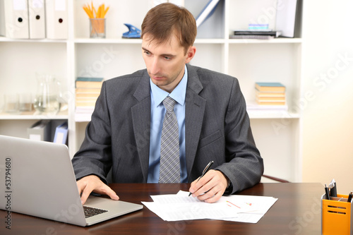 Young businessman in office...