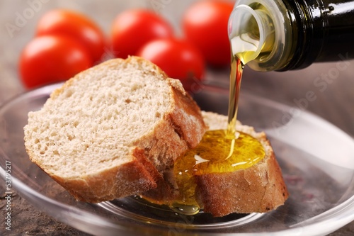 Close-up of olive oil pouring on slices of bread