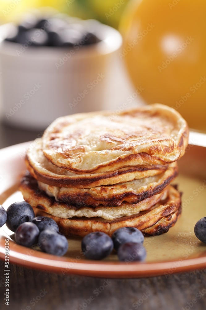 Stack of pancakes with blueberries and orange juice Stack of pancakes with blueberries and orange juice