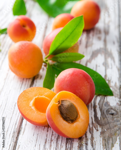 Fresh apricot with leaf on a wooden board