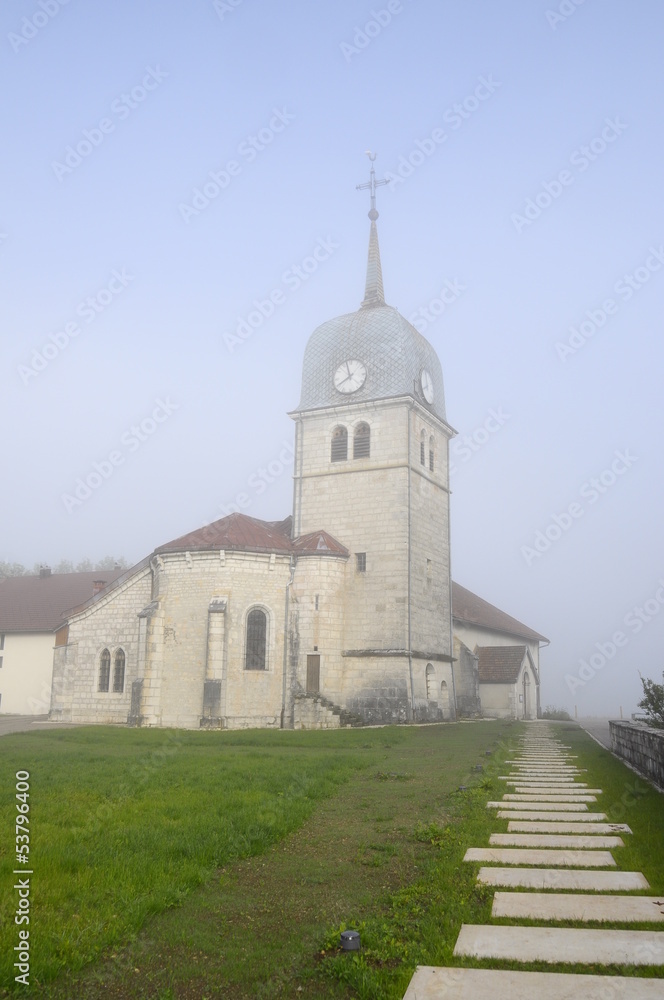 Abbey church in Jura, France and cure (house of the priest).
