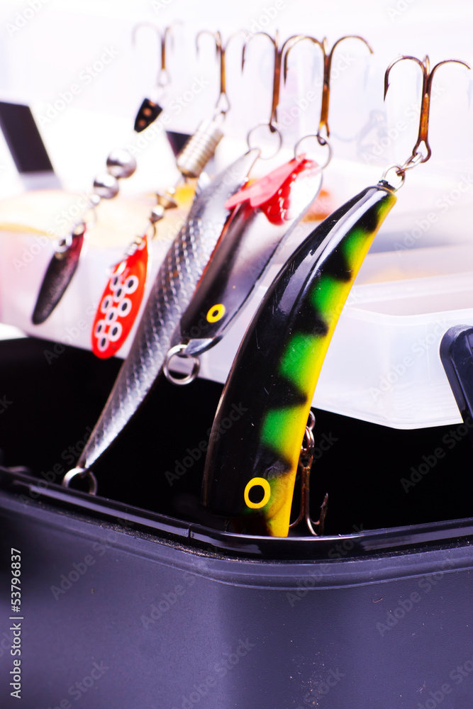 Fototapeta premium Opened fishing box with lures on a white background