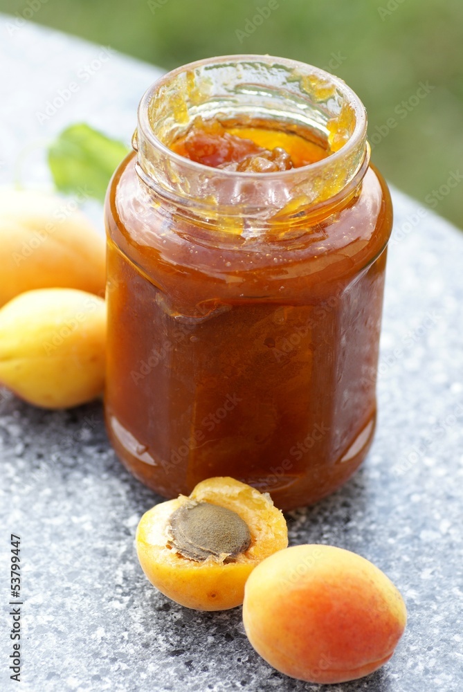 Glass with apricot jam and fresh apricots Glass with apricot jam and fresh apricots