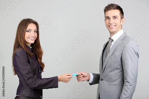 Successful business people changing business cards