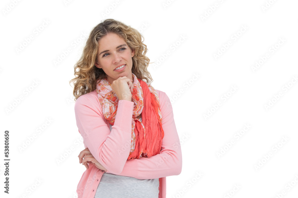 Blonde thoughtful woman smiling while touching her chin Blonde thoughtful woman smiling while touching her chin