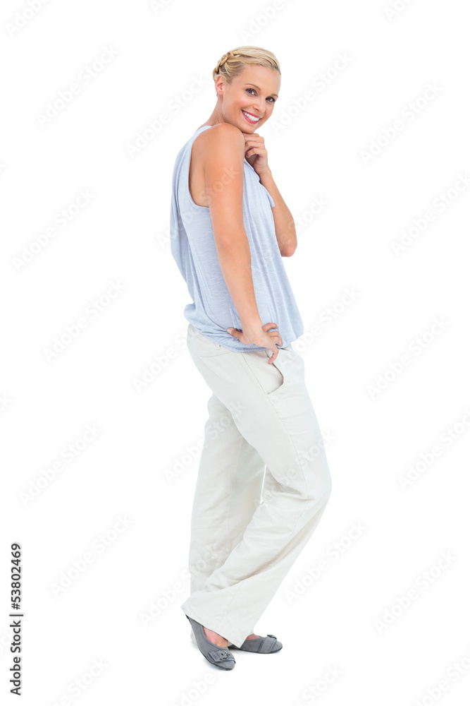 Blonde woman smiling with hand on hip looking at camera Blonde woman smiling with hand on hip looking at camera