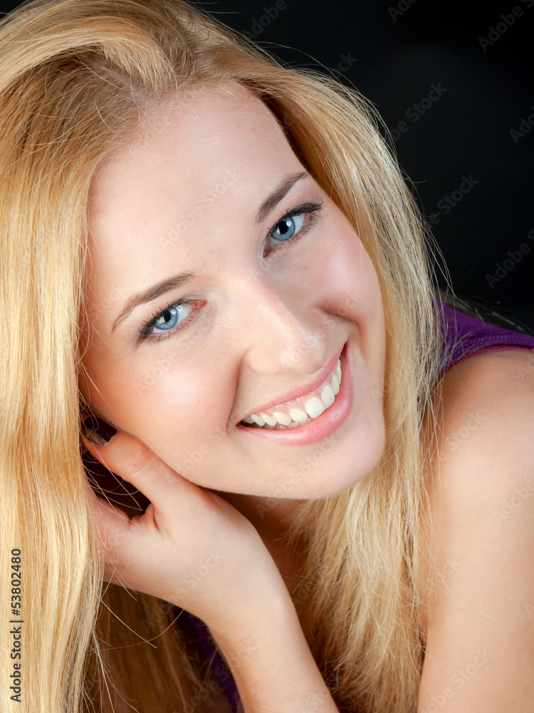 Portrait of the long-haired blonde with a white teeth smile Portrait of the long-haired blonde with a white teeth smile