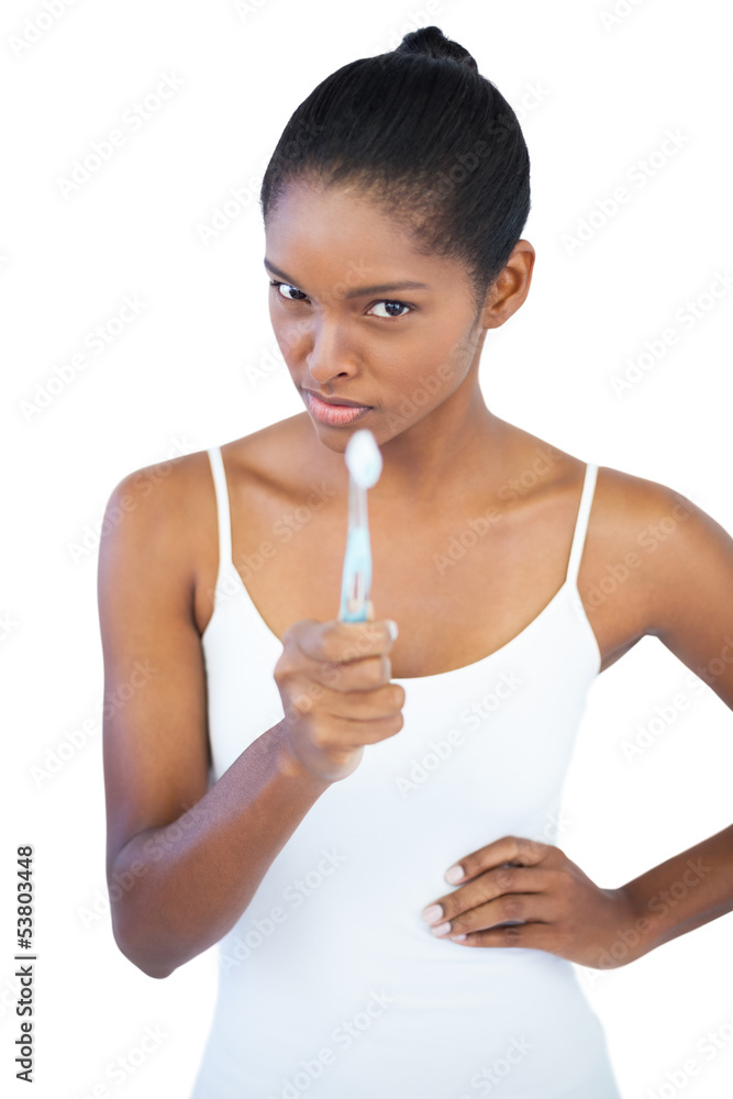 Woman pointing at camera with her toothbrush Woman pointing at camera with her toothbrush