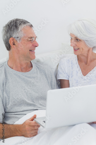 Cheerful mature couple using a laptop © WavebreakmediaMicro