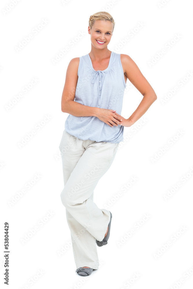 Woman smiling with hand on hip looking at camera Woman smiling with hand on hip looking at camera