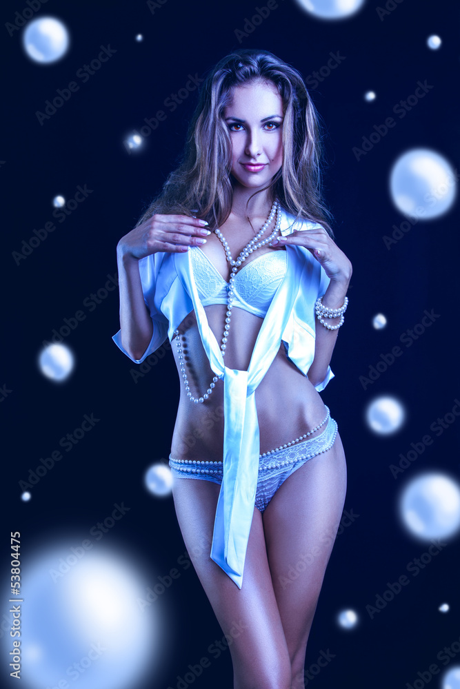 Cold tones photo of pretty woman in lingerie and lots of pearls