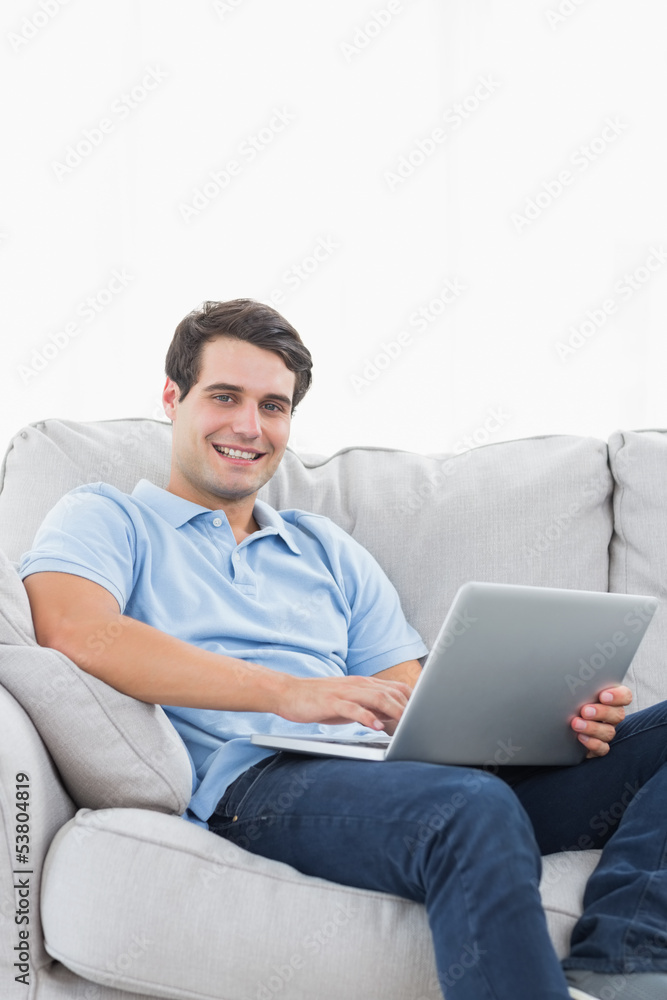 Portrait of a cheerful man using his laptop Portrait of a cheerful man using his laptop